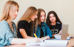 teens using laptop school